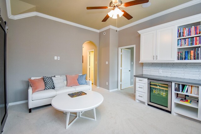 5006 Isidore Ln, Missouri City, TX 77459 - living area with arched walkways, a ceiling fan, light carpet, baseboards, and ornamental molding