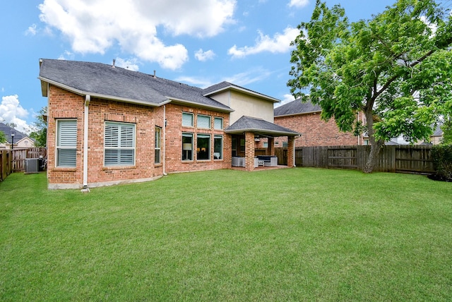 5006 Isidore Ln, Missouri City, TX 77459 - rear view of property with cooling unit, brick siding, and a patio