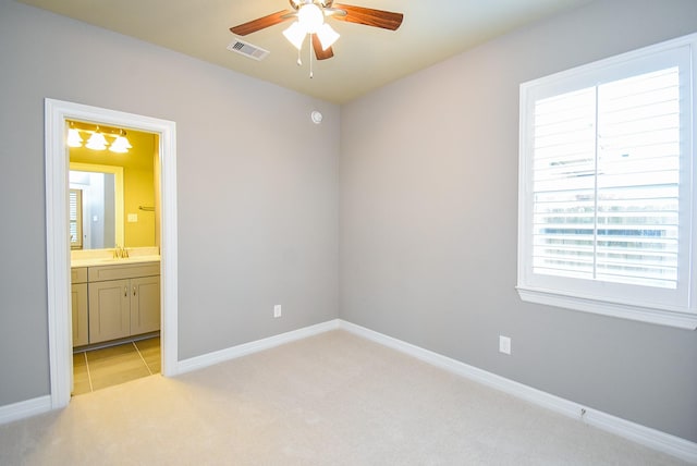 5006 Isidore Ln, Missouri City, TX 77459 - unfurnished bedroom with a sink, light colored carpet, connected bathroom, and baseboards