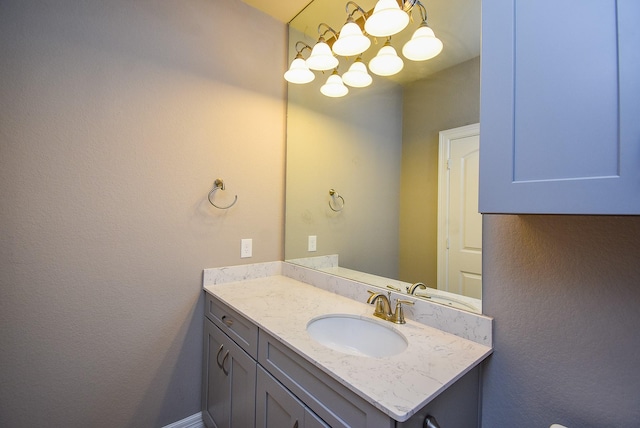 5006 Isidore Ln, Missouri City, TX 77459 - bathroom with vanity, a chandelier, and a textured wall