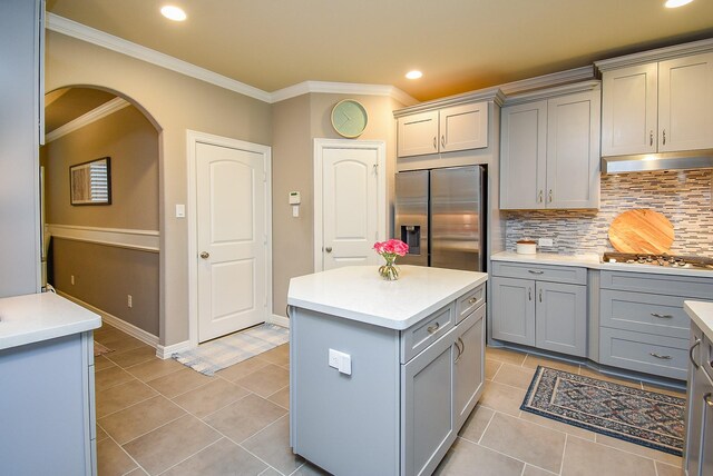 5006 Isidore Ln, Missouri City, TX 77459 - kitchen with gray cabinetry, appliances with stainless steel finishes, crown molding, light countertops, and light tile patterned flooring