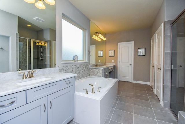 5006 Isidore Ln, Missouri City, TX 77459 - bathroom with a stall shower, tile patterned flooring, two vanities, and a bath