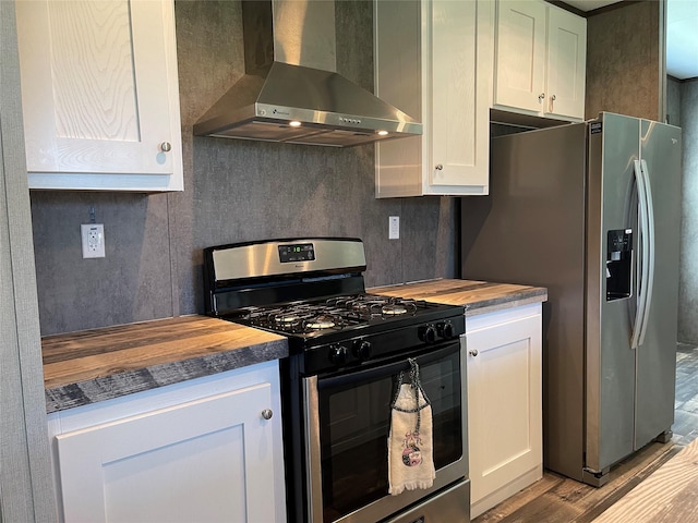 322 E College St, Fairfield, TX 75840 - kitchen with appliances with stainless steel finishes, wall chimney range hood, butcher block countertops, and wood finished floors