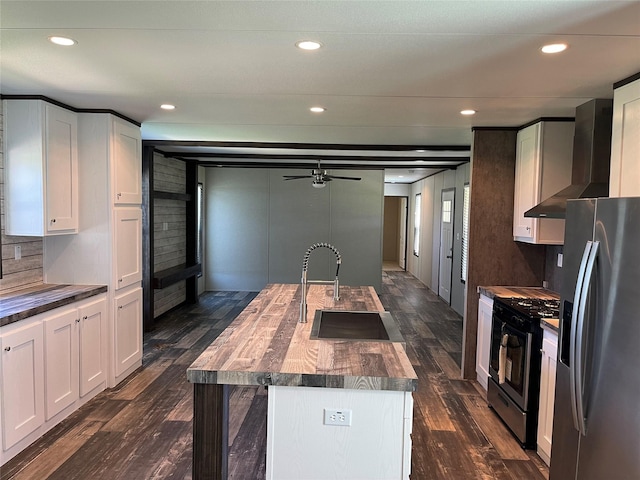 322 E College St, Fairfield, TX 75840 - kitchen with appliances with stainless steel finishes, a sink, wall chimney exhaust hood, butcher block countertops, and dark wood-style floors