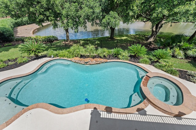 view of pool featuring fence, a water view, and a pool with connected hot tub