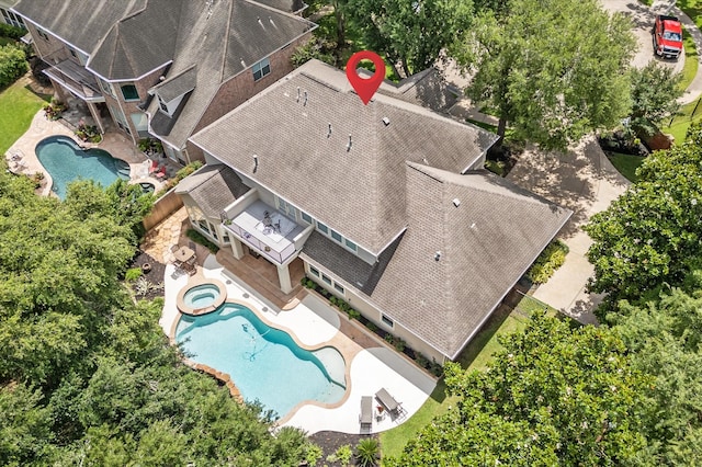 aerial view of property and surrounding area with a pool area