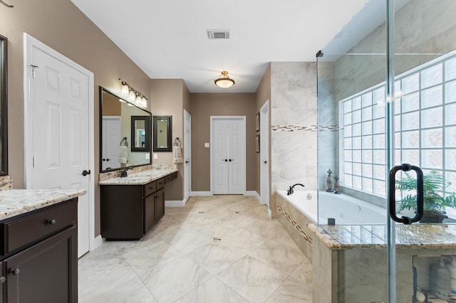 bathroom featuring a garden tub, vanity, and baseboards