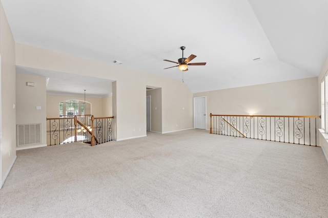 carpeted spare room featuring ceiling fan, baseboards, and lofted ceiling