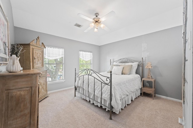 bedroom with baseboards, light colored carpet, and a ceiling fan