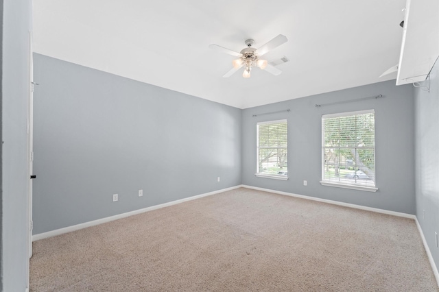 empty room with ceiling fan, carpet, and baseboards