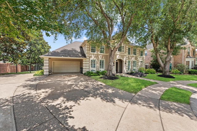 view of front of property with a garage, concrete driveway, and a shingled roof