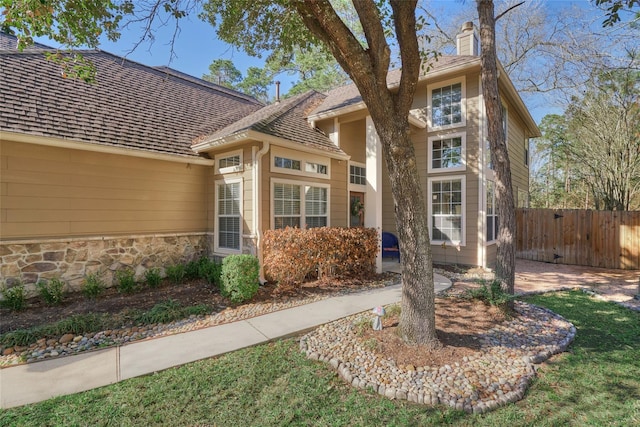 70 Harvest Wind Pl, The Woodlands, TX 77382 - view of front of property with fence and a chimney