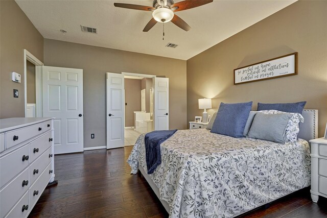 70 Harvest Wind Pl, The Woodlands, TX 77382 - bedroom featuring dark wood finished floors, baseboards, ensuite bath, and ceiling fan