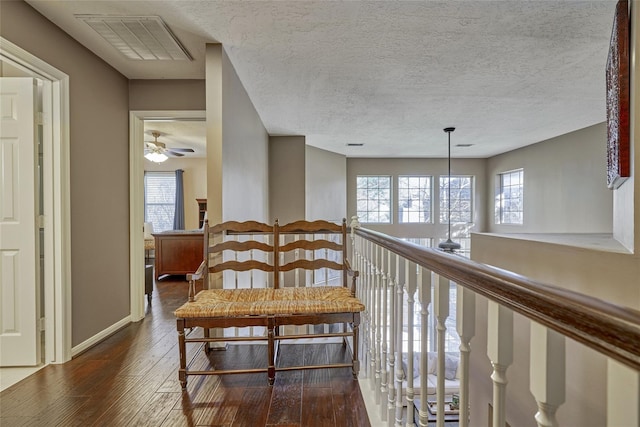 70 Harvest Wind Pl, The Woodlands, TX 77382 - hall featuring hardwood / wood-style flooring, plenty of natural light, a textured ceiling, and baseboards