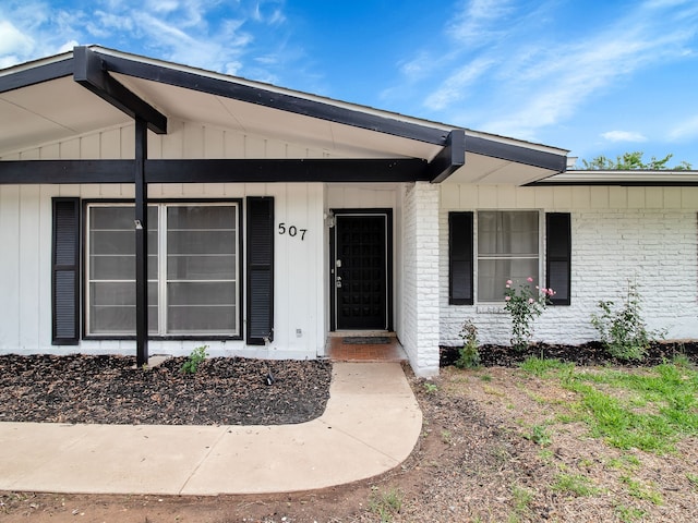 507 Patricia, San Antonio, TX 78216 - view of exterior entry featuring brick siding, board and batten siding, and a porch