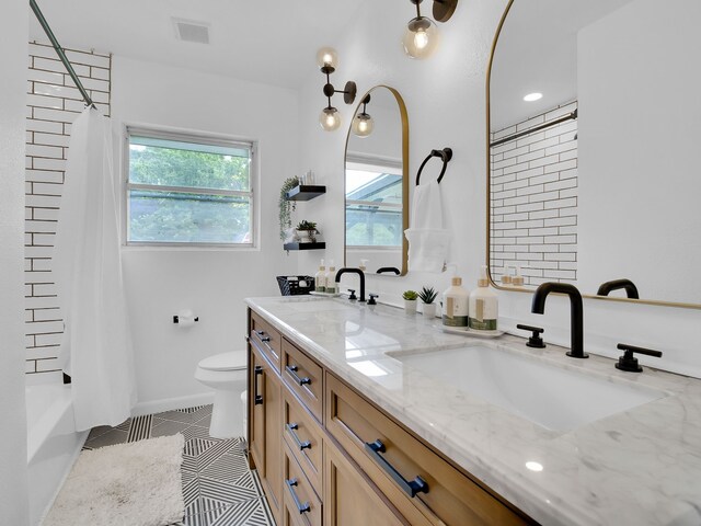 507 Patricia, San Antonio, TX 78216 - bathroom with tile patterned floors, double vanity, toilet, and shower / tub combo