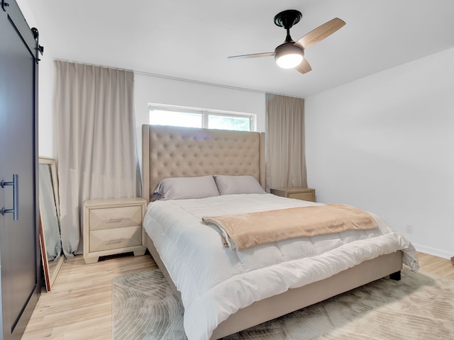 507 Patricia, San Antonio, TX 78216 - bedroom with light wood finished floors, a barn door, and ceiling fan