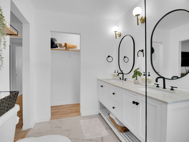 507 Patricia, San Antonio, TX 78216 - full bathroom with marble look tiles, toilet, double vanity, and baseboards