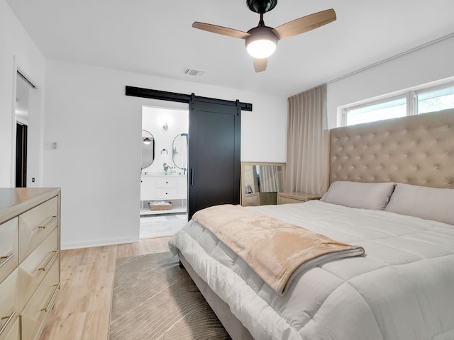 507 Patricia, San Antonio, TX 78216 - bedroom with a barn door, light wood-style floors, and ceiling fan