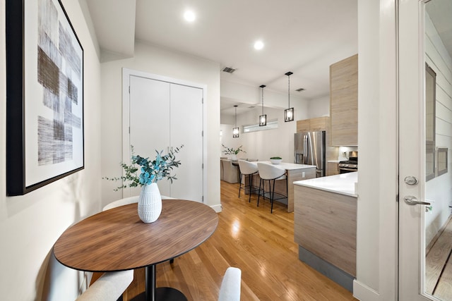 2705 St Emanuel St, Houston, TX 77004 - dining space with light wood-style flooring and recessed lighting