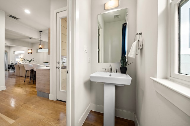 2705 St Emanuel St, Houston, TX 77004 - bathroom featuring baseboards, wood finished floors, and recessed lighting