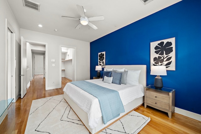 2705 St Emanuel St, Houston, TX 77004 - bedroom with wood finished floors, baseboards, a ceiling fan, a walk in closet, and recessed lighting