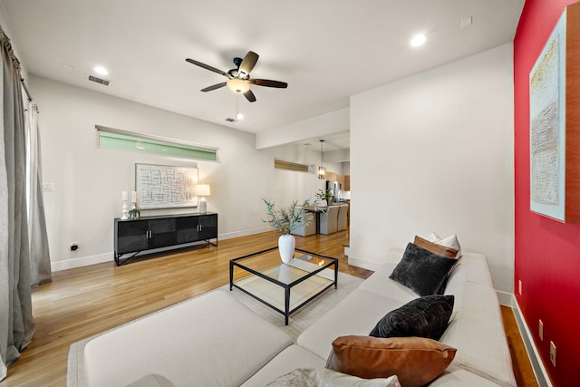 2705 St Emanuel St, Houston, TX 77004 - living area featuring wood finished floors, ceiling fan, baseboards, and recessed lighting