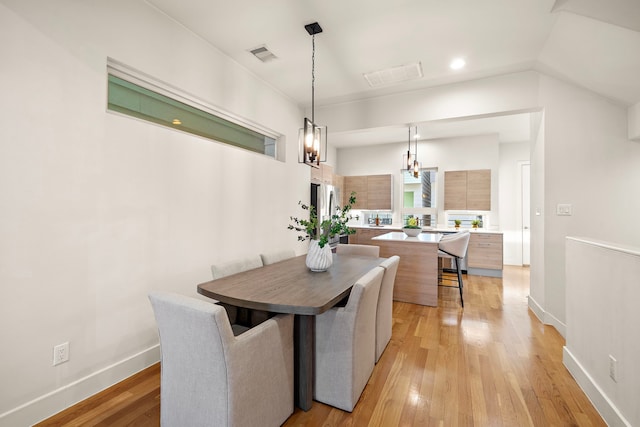 2705 St Emanuel St, Houston, TX 77004 - dining space with light wood-style flooring, baseboards, a chandelier, and recessed lighting