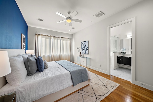 2705 St Emanuel St, Houston, TX 77004 - bedroom with baseboards, light wood finished floors, connected bathroom, and a ceiling fan