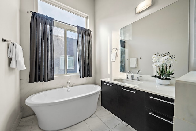 2705 St Emanuel St, Houston, TX 77004 - bathroom featuring vanity, a freestanding bath, marble look tile flooring, and baseboards