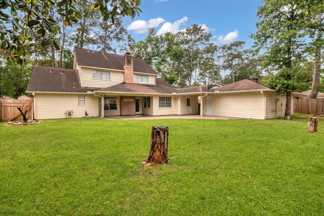 rear view of property with a patio and a chimney