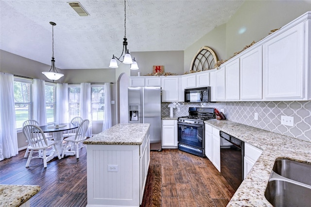 923 Garrett Dr, Magnolia, TX 77354 - kitchen featuring black appliances, dark wood-style floors, a textured ceiling, backsplash, and white cabinets