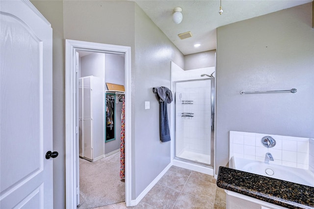 923 Garrett Dr, Magnolia, TX 77354 - full bath with a shower stall, a walk in closet, baseboards, and a bath