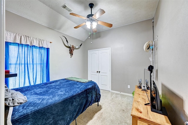 923 Garrett Dr, Magnolia, TX 77354 - carpeted bedroom featuring lofted ceiling, a ceiling fan, baseboards, a closet, and a textured ceiling