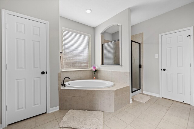 22726 Little Blue Stem Dr, Tomball, TX 77375 - full bathroom with tile patterned floors, a stall shower, a bath, and baseboards
