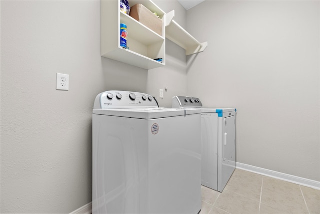 22726 Little Blue Stem Dr, Tomball, TX 77375 - clothes washing area featuring washer and clothes dryer, baseboards, and light tile patterned flooring
