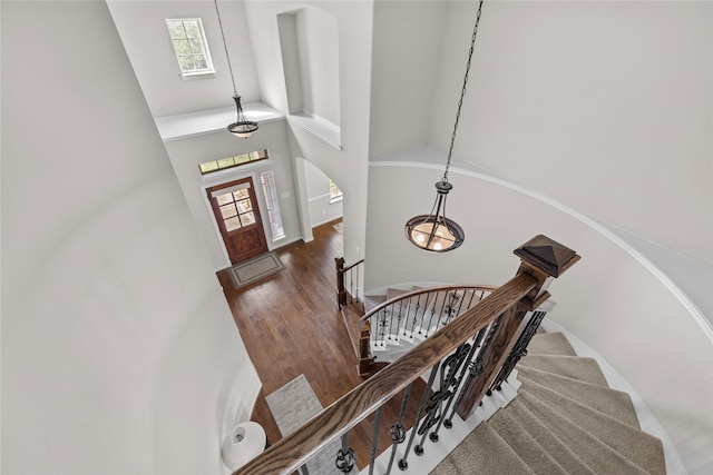 22726 Little Blue Stem Dr, Tomball, TX 77375 - entryway featuring arched walkways, high vaulted ceiling, plenty of natural light, and wood finished floors