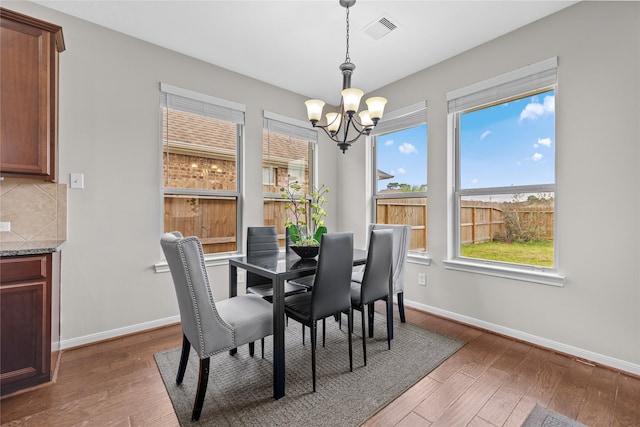 22726 Little Blue Stem Dr, Tomball, TX 77375 - dining space featuring a chandelier, baseboards, and wood finished floors