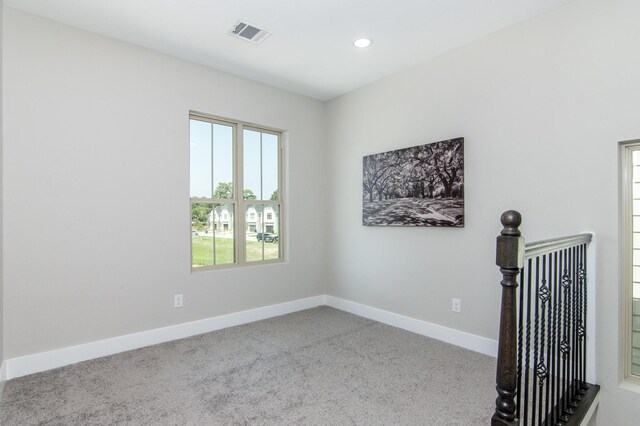 carpeted spare room featuring baseboards and recessed lighting
