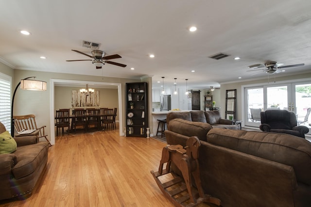 11107 Atwell Dr, Houston, TX 77096 - living room featuring a ceiling fan, recessed lighting, ornamental molding, a chandelier, and light wood-type flooring