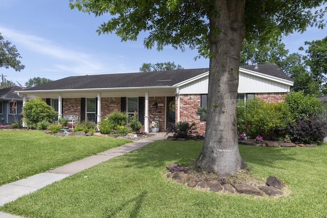 11107 Atwell Dr, Houston, TX 77096 - ranch-style home featuring brick siding, a front yard, and covered porch