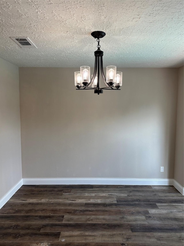 402 Boone Ct, Deer Park, TX 77536 - unfurnished room with a chandelier, dark wood-style floors, baseboards, and a textured ceiling