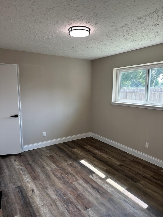 402 Boone Ct, Deer Park, TX 77536 - unfurnished room with dark wood finished floors, a textured ceiling, and baseboards