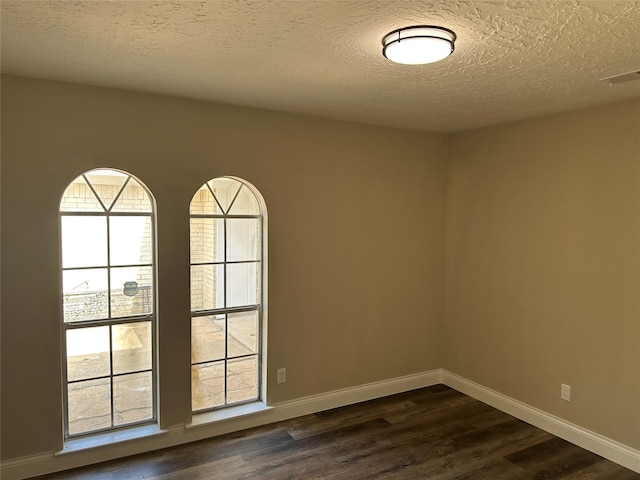 402 Boone Ct, Deer Park, TX 77536 - spare room featuring dark wood finished floors, a textured ceiling, and baseboards