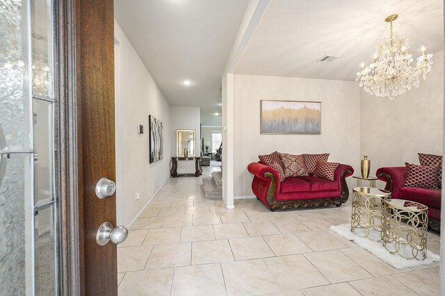 tiled living room with a chandelier, baseboards, and recessed lighting
