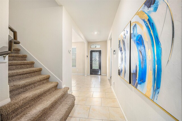 foyer entrance featuring stairway, light tile patterned flooring, baseboards, and recessed lighting