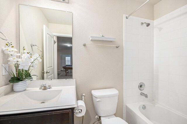 bathroom featuring toilet, shower / washtub combination, and vanity
