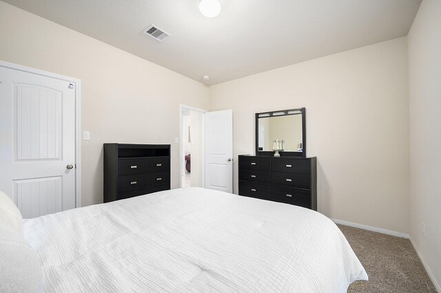 bedroom with carpet flooring and baseboards
