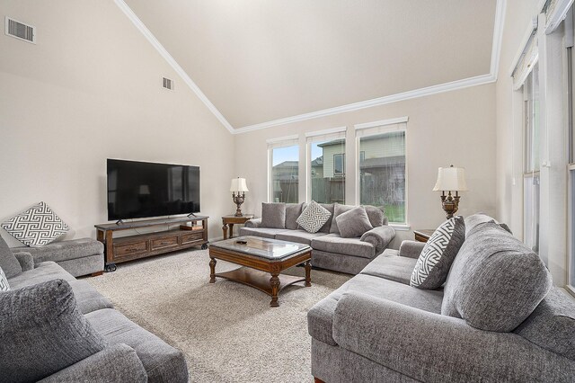 living area featuring crown molding, light carpet, and high vaulted ceiling