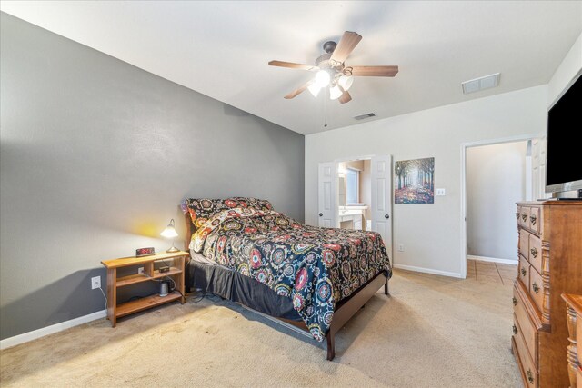 bedroom with carpet floors, baseboards, a ceiling fan, and connected bathroom
